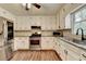 Bright kitchen with white cabinets, granite countertops, and stainless steel appliances at 2816 Highland Park Dr, Stone Mountain, GA 30087