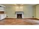 Bright living room with fireplace, built-in shelving and hardwood floors at 2816 Highland Park Dr, Stone Mountain, GA 30087