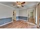 Bright living room with new wood flooring, two-tone paint, white trim, and natural light at 2816 Highland Park Dr, Stone Mountain, GA 30087