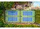 Community tennis courts viewed from above, showing well-maintained blue courts and lush greenery at 2735 Jims Ne Rd, Marietta, GA 30066