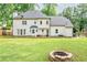 Back exterior view showing the fire pit, patio, and fenced in yard at 2735 Jims Ne Rd, Marietta, GA 30066
