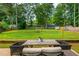 Large, lush backyard with mature trees, a play structure, and an outdoor seating area at 2735 Jims Ne Rd, Marietta, GA 30066