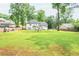 Expansive backyard featuring lush green lawn and mature trees, ideal for outdoor activities and relaxation at 2735 Jims Ne Rd, Marietta, GA 30066