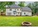 Large backyard showcasing the home's exterior, a cozy outdoor seating area, and a charming fire pit at 2735 Jims Ne Rd, Marietta, GA 30066