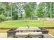 Spacious backyard features a dining table, swing set, and fire pit, perfect for outdoor entertainment at 2735 Jims Ne Rd, Marietta, GA 30066