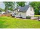 Expansive backyard featuring a lush lawn, wood fence, and patio seating perfect for outdoor enjoyment at 2735 Jims Ne Rd, Marietta, GA 30066