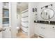 Clean bathroom featuring white cabinets, granite countertops, and decorative round mirror at 2735 Jims Ne Rd, Marietta, GA 30066