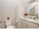 Charming half bathroom featuring marble countertop, gold round mirror and modern fixtures at 2735 Jims Ne Rd, Marietta, GA 30066