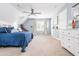 Spacious bedroom featuring a blue bed, ceiling fan, and carpeted floors at 2735 Jims Ne Rd, Marietta, GA 30066