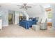 Spacious bedroom featuring a blue bed, gray rocking chair, and carpeted floors at 2735 Jims Ne Rd, Marietta, GA 30066