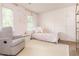 Charming bedroom with pink walls, white paneled accent wall, and beautiful natural light at 2735 Jims Ne Rd, Marietta, GA 30066