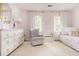Charming pink bedroom with crib, white dresser with gold knobs and plenty of natural light at 2735 Jims Ne Rd, Marietta, GA 30066