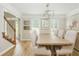 Bright dining room features a rustic wood table, stylish chandelier, and hardwood floors at 2735 Jims Ne Rd, Marietta, GA 30066
