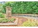 Stone entrance sign for Windsor Oaks neighborhood, complemented by manicured landscaping and greenery at 2735 Jims Ne Rd, Marietta, GA 30066