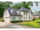 Side view of this two-story home shows brick, siding, driveway, manicured lawn and tidy landscape at 2735 Jims Ne Rd, Marietta, GA 30066