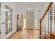 Bright foyer boasts hardwood floors, white trim, and glass-paneled French doors at 2735 Jims Ne Rd, Marietta, GA 30066