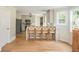 Open-concept kitchen with bar seating, stainless steel appliances, and wood floors at 2735 Jims Ne Rd, Marietta, GA 30066