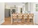 Open-concept kitchen with bar seating, stainless steel appliances, and wood floors at 2735 Jims Ne Rd, Marietta, GA 30066