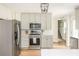 Contemporary kitchen with stainless steel appliances, white countertops and light wood floors at 2735 Jims Ne Rd, Marietta, GA 30066