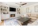 Comfortable living room with fireplace, built-in bookshelves, ceiling fan and decorative rug at 2735 Jims Ne Rd, Marietta, GA 30066