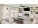 Bright living room with fireplace, built-in bookshelves, ceiling fan and natural light at 2735 Jims Ne Rd, Marietta, GA 30066