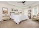 Spacious main bedroom featuring tray ceiling, neutral tones, and sitting area at 2735 Jims Ne Rd, Marietta, GA 30066