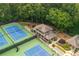 Aerial perspective of tennis courts and clubhouse surrounded by mature trees and landscape at 2735 Jims Ne Rd, Marietta, GA 30066