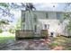 Backyard view of home with wood deck and door, along with ample yard space at 5920 Hampton Ct, College Park, GA 30349