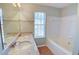 Well-lit bathroom with dual sinks, granite countertops, a soaking tub, and a separate shower at 5920 Hampton Ct, College Park, GA 30349