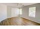 Bright bedroom with neutral walls, hardwood floors, ceiling fan, and double door closet at 5920 Hampton Ct, College Park, GA 30349
