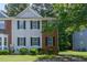 Two-story townhouse featuring a mix of brick and vinyl siding with black shutters and well-maintained front lawn at 5920 Hampton Ct, College Park, GA 30349