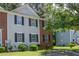 Charming townhome featuring a combination of brick and siding, complemented by black shutters and a well-maintained lawn at 5920 Hampton Ct, College Park, GA 30349