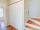 Hallway with wood-look floors, staircase, and a closet for storage space at 5920 Hampton Ct, College Park, GA 30349