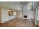 Open-concept living space with hardwood floors, a fireplace, and seamless flow into the kitchen area at 5920 Hampton Ct, College Park, GA 30349