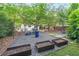 Large backyard with custom landscaping, featuring gravel seating area, planter boxes and mature trees at 1267 Thomas Rd, Decatur, GA 30030