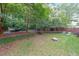 Lush backyard featuring a hammock, manicured hedges, a fire pit, and a seating area for outdoor relaxation at 1267 Thomas Rd, Decatur, GA 30030