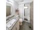 Well-lit bathroom with a granite countertop vanity and shower-tub combo at 1267 Thomas Rd, Decatur, GA 30030