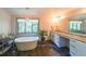 Luxurious bathroom featuring a soaking tub, granite countertops, and ample natural light at 1267 Thomas Rd, Decatur, GA 30030