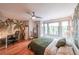 Bedroom featuring hardwood floors, a ceiling fan, and ample natural light from large windows at 1267 Thomas Rd, Decatur, GA 30030