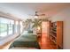 Bright bedroom with hardwood floors, palm tree wallpaper and a ceiling fan at 1267 Thomas Rd, Decatur, GA 30030