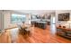 Open dining area with hardwood floors, a large window, and access to the modern kitchen at 1267 Thomas Rd, Decatur, GA 30030
