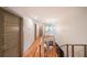 Well-lit hallway with hardwood floors, modern railings, and access to multiple rooms at 1267 Thomas Rd, Decatur, GA 30030