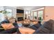 Inviting living room featuring stylish sofas, a cozy fireplace, and sunlit windows with access to an outdoor area at 1267 Thomas Rd, Decatur, GA 30030