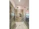 Modern bathroom shower with glass door and rainfall shower head, tiled with gray stone at 1267 Thomas Rd, Decatur, GA 30030