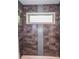 Shower with gray stone tiles and a window view at 1267 Thomas Rd, Decatur, GA 30030