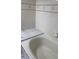 Bathroom displaying a tub, tiled walls, and a marble countertop at 311 Indus Ln, Lawrenceville, GA 30044