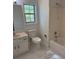 Bathroom featuring a vanity sink, toilet, shower, and tiled flooring at 311 Indus Ln, Lawrenceville, GA 30044