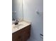 Bathroom showcasing a single sink vanity with a countertop, dark fixtures, and wooden cabinets at 311 Indus Ln, Lawrenceville, GA 30044