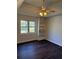 Bedroom featuring hardwood floors, a ceiling fan with light, and a built-in bookshelf at 311 Indus Ln, Lawrenceville, GA 30044