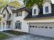 Charming two-story home featuring a brick accent, a covered entryway, and an attached two-car garage at 311 Indus Ln, Lawrenceville, GA 30044